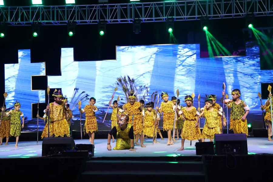 Students in costume dancing on stage